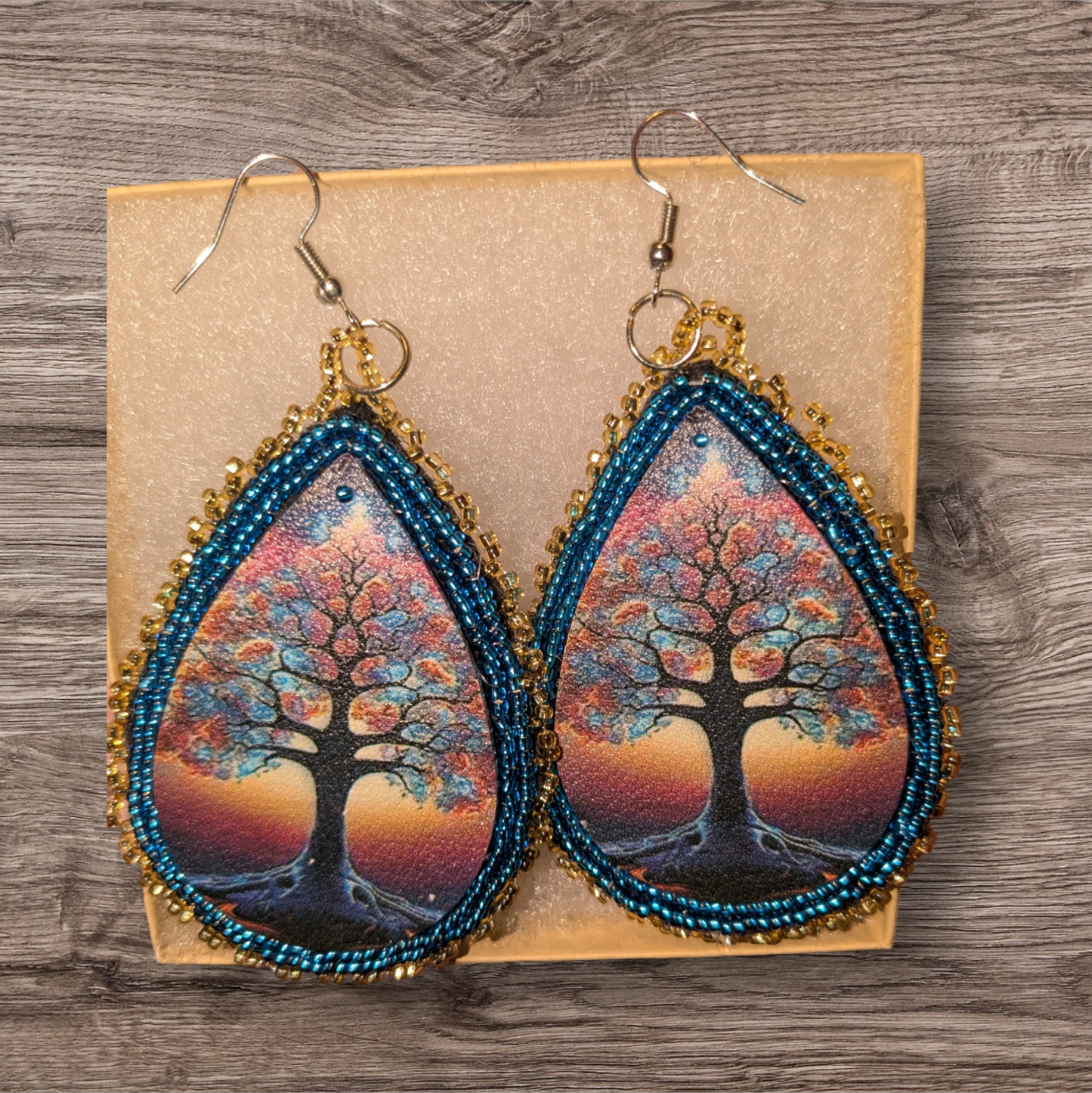 Beaded leather drop earrings  with blue and gold edging,