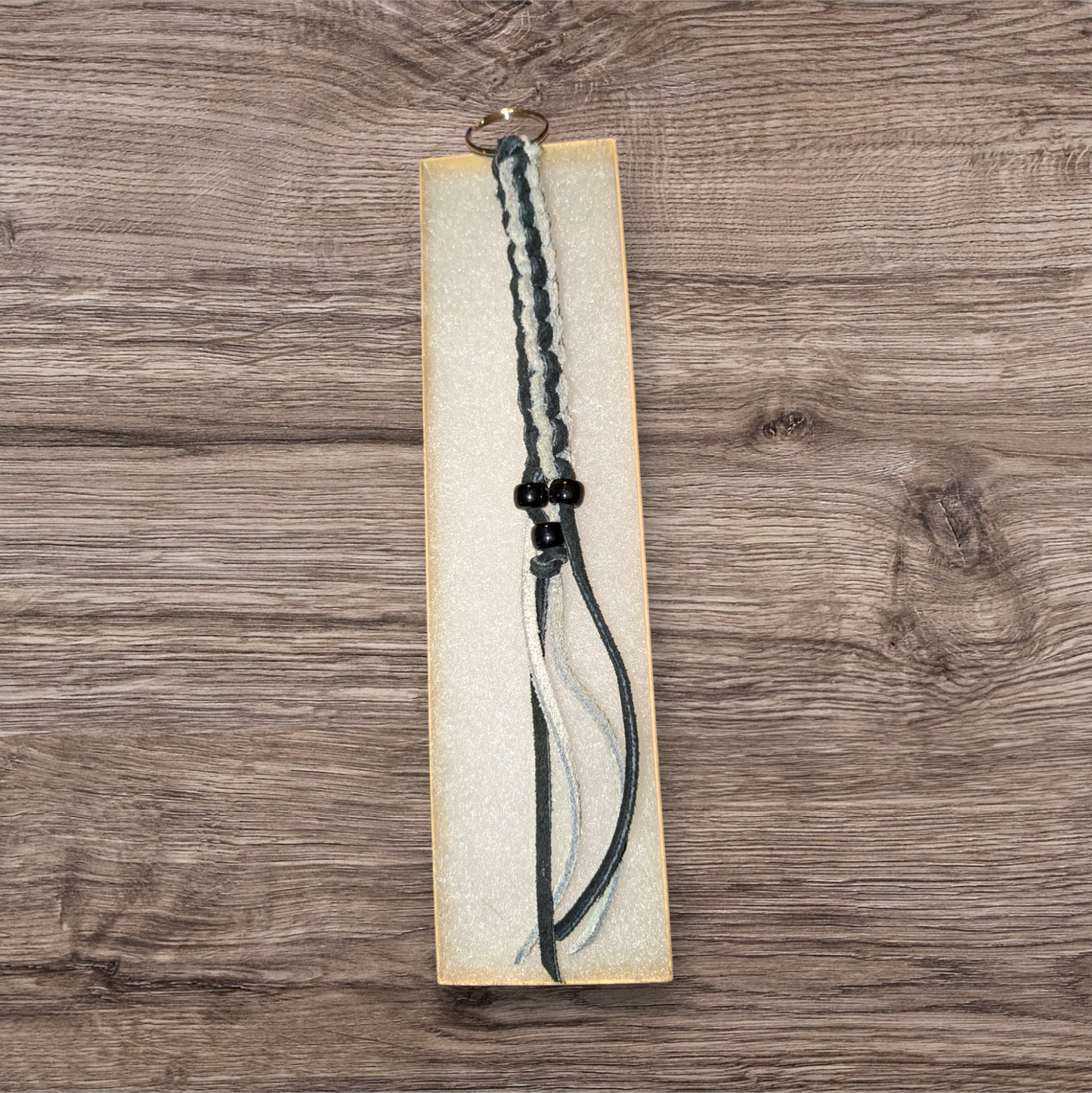 Small black and white box braided leather keychain